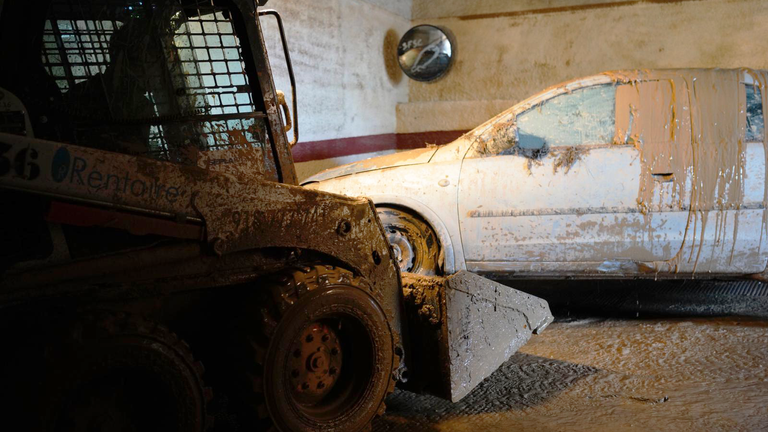 Photos from Adam Parsons in Catarroja, Spain at an underground car park where people are cleaning up after flooding
