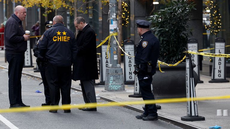 Police officers stand near the scene where the CEO of United Healthcare Brian Thompson was reportedly shot and killed in Midtown Manhattan.
Pic: Reuters