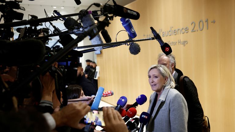 French far-right leader Marine Le Pen, member of parliament of the Rassemblement National (National Rally - RN) party, talks to journalists as she arrives with her lawyer Rodolphe Bosselut for her trial alongside 26 other defendants (party officials and employees, former lawmakers and parliamentary assistants) and the RN party itself, over alleged misappropriation of European Union funds, using money intended to pay FN-RN parliamentary assistants for party staff between 2004 and 2016, at the cou