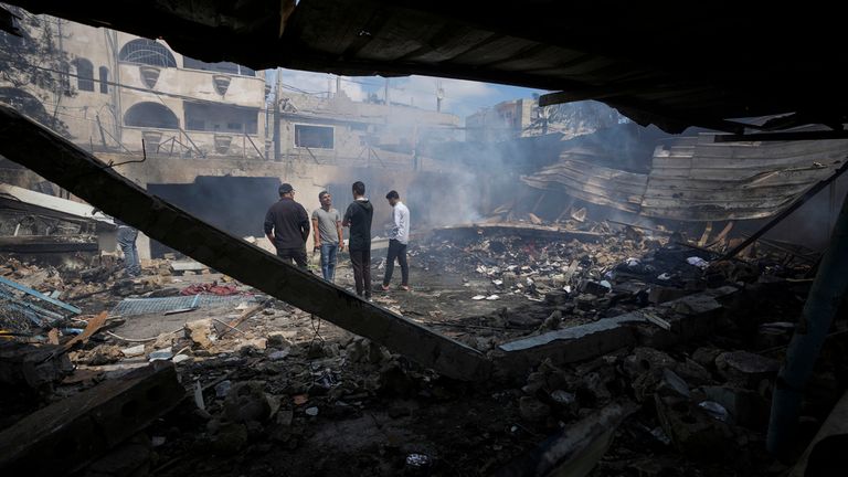 Palestinians look at the destruction after an Israeli strike on a school run by UNRWA, the U.N. agency helping Palestinian refugees, in Nuseirat, Gaza Strip, Tuesday, May 14, 2024. (AP Photo/Abdel Kareem Hana)