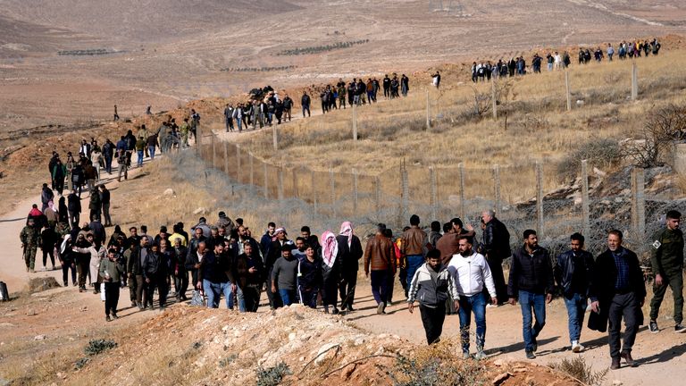 A line of people heads toward Saydnaya military prison, just north of Damascus, Syria.
Pic: AP